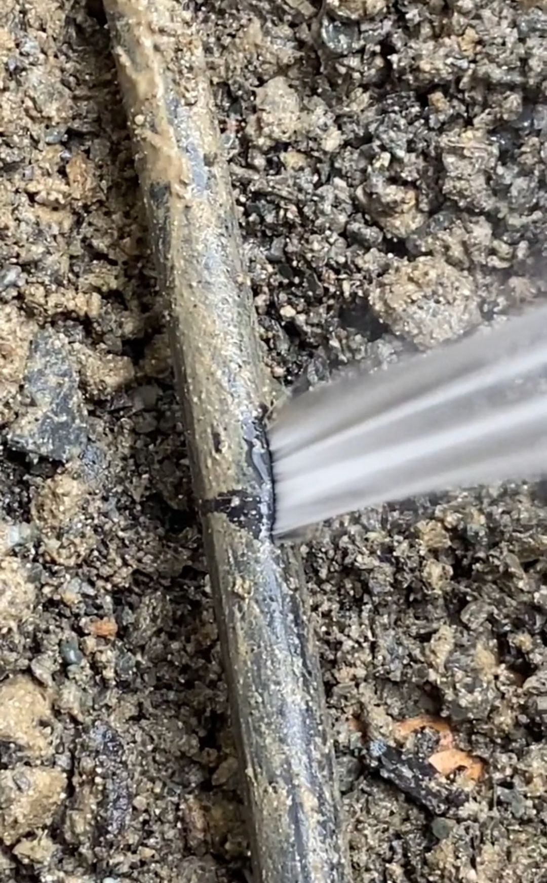 A Close Up of a Hose With Water bursting out of a leak — Dowds Pipe and Cable Locating in Farmborough Heights, NSW