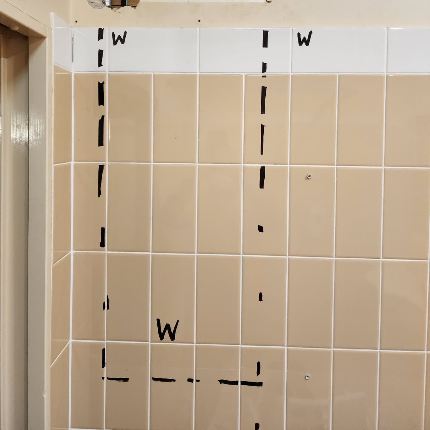 A Tiled Wall With the Word Written on It — Dowds Pipe and Cable Locating in Farmborough Heights, NSW