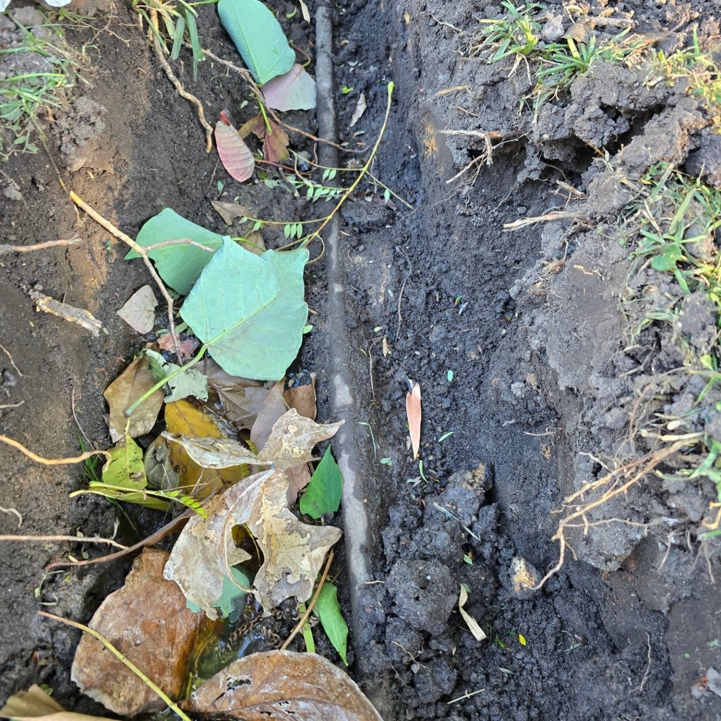 A pipe is partially dug up — Dowds Pipe and Cable Locating in Farmborough Heights, NSW