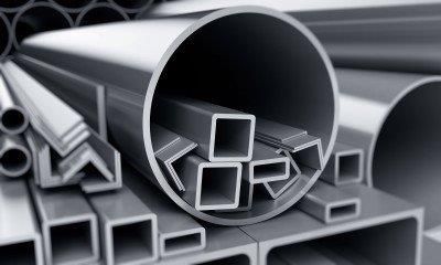 A pile of stainless steel pipes and square pipes stacked on top of each other.
