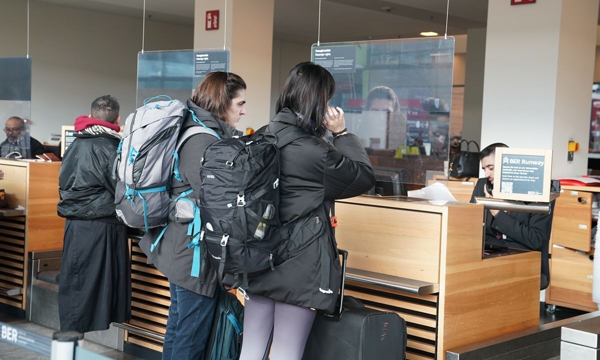 Foreign tourists check in for a flight to China at the airport in Berlin on December 1, 2023, the day when China starts implementing a visa-free program for ordinary passport holders from France, Germany, Italy, the Netherlands, Spain and Malaysia on a trial basis. 