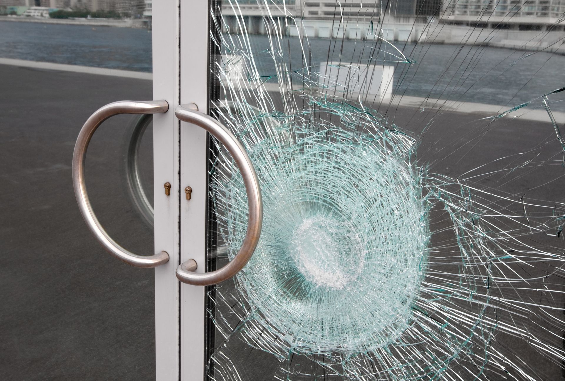 Shattered glass door panel showing visible cracks and broken sections.