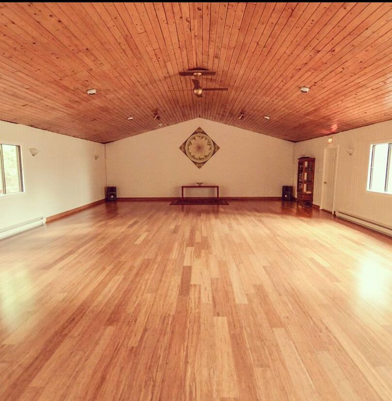 An empty room with a wooden floor and ceiling