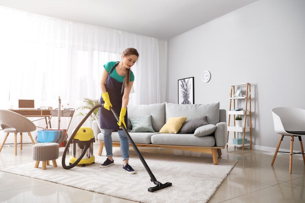 A Cleaner Cleans A Carpet Using Vacuum — Toowoomba Cleaning Co in South Toowoomba, QLD