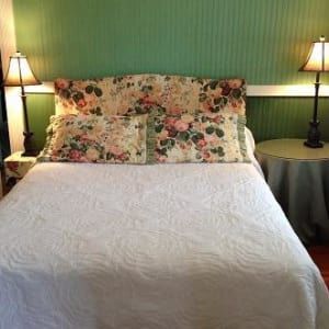 A bedroom with a four poster bed and a couch