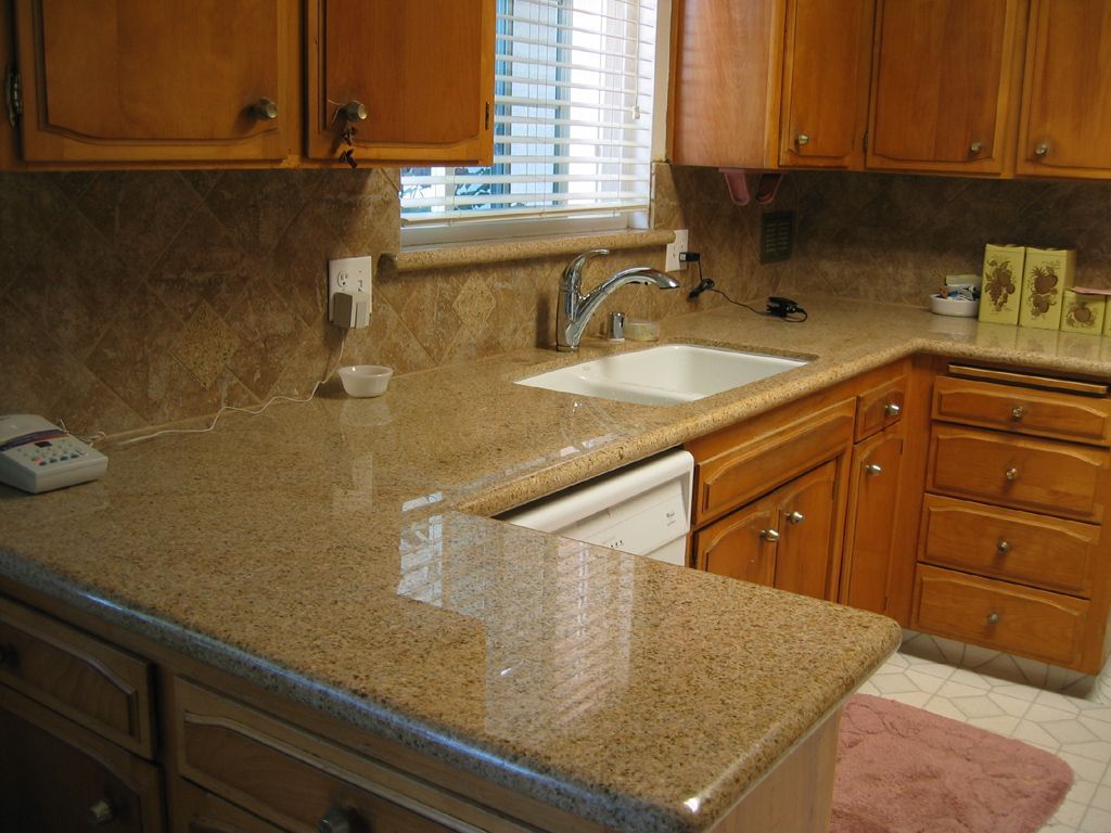 A kitchen with a sink and a phone on the counter