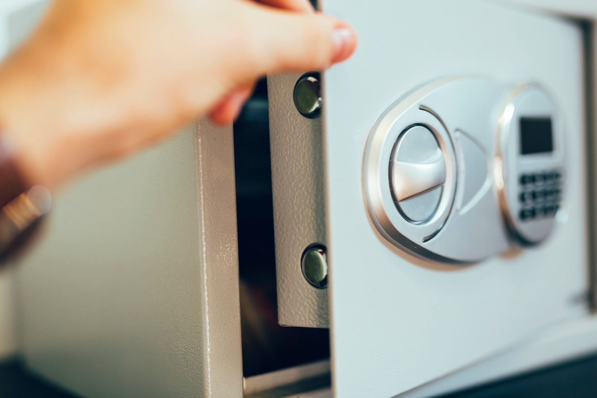 A Person Is Opening a Safe with A Digital Lock.