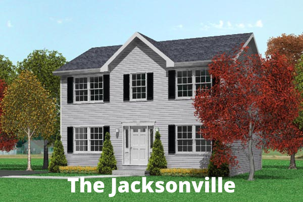 A white house with black shutters is sitting on top of a lush green field.