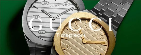 Due orologi Gucci, uno argentato e uno dorato, con quadrante bianco e nero e cinturino in metallo.