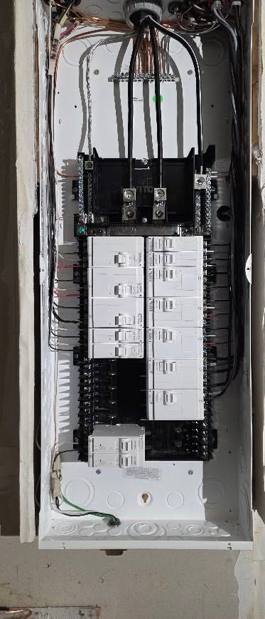 Open electrical breaker panel with rows of white breakers and exposed wiring in a metal box