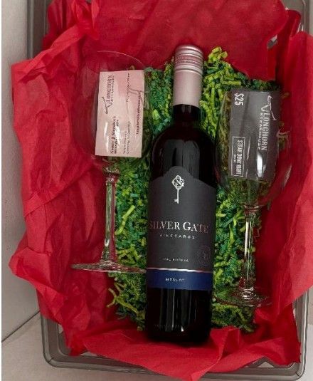 Gift basket with stuffed dog, packaged in clear cellophane, with a handwritten tag.