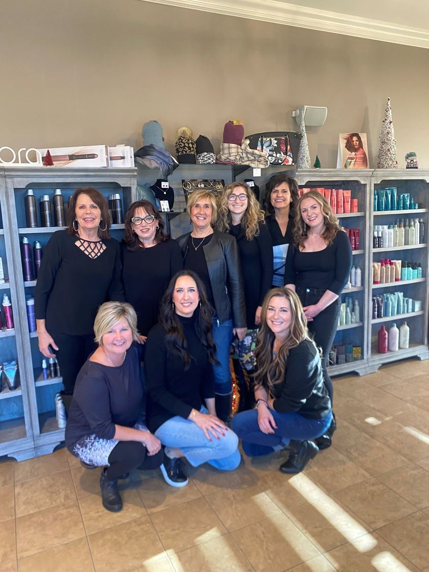 A group of women are posing for a picture in a salon.