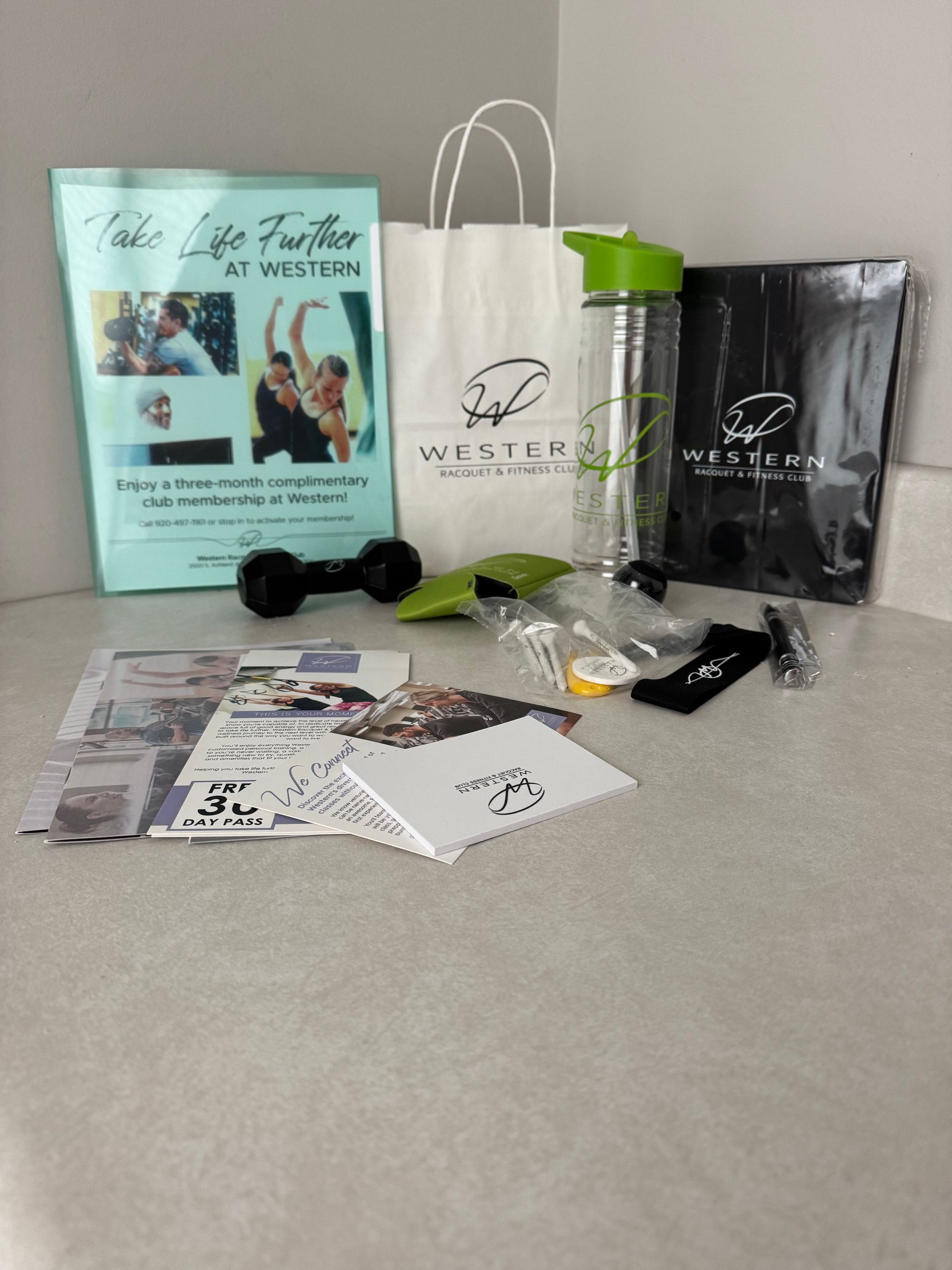 Assorted skincare products, brochures, and gift bags arranged on a countertop