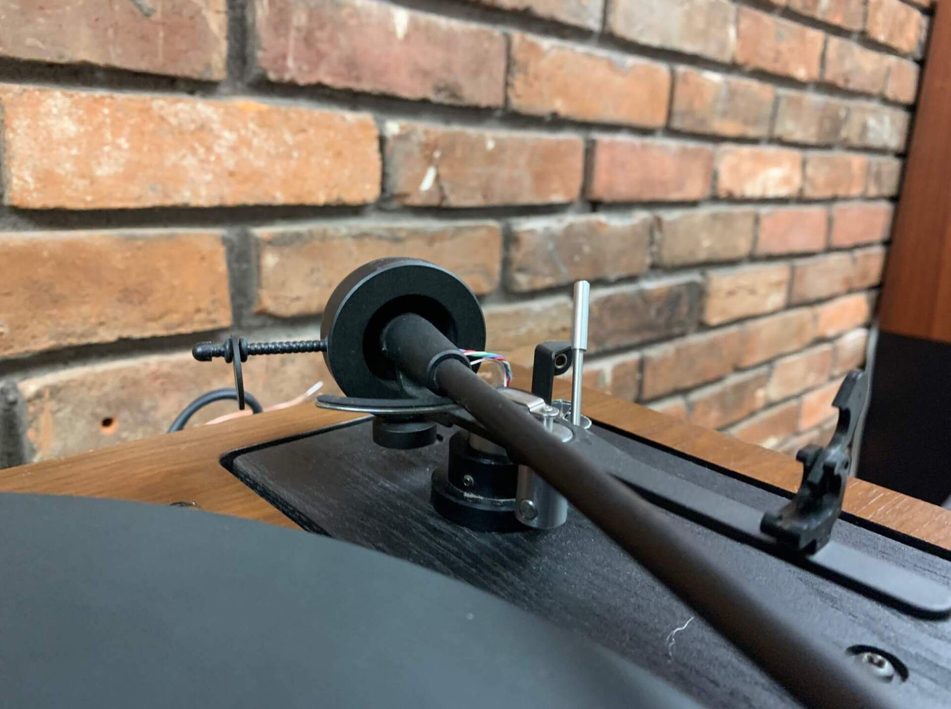 Wiper blades on a car windshield against a brick wall background