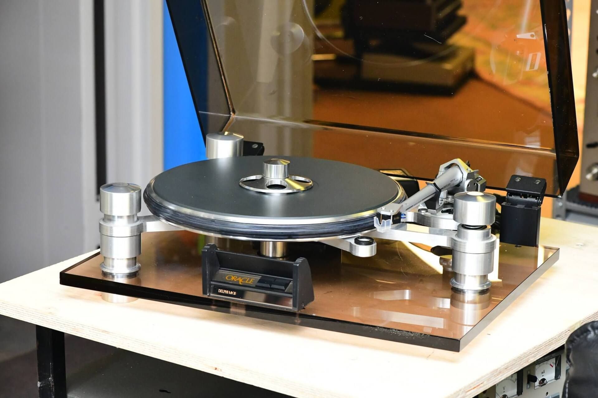 Turntable-style machine with a black platter on a white table in a lab-like setting