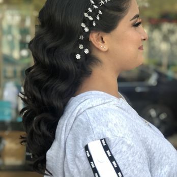 A woman with long curly hair and a tiara on her head.