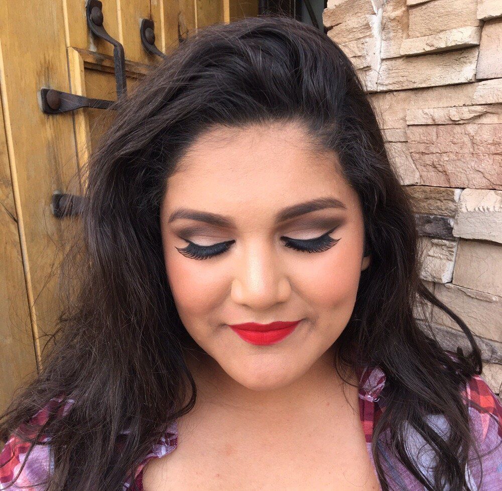 A close up of a woman's face with red lipstick