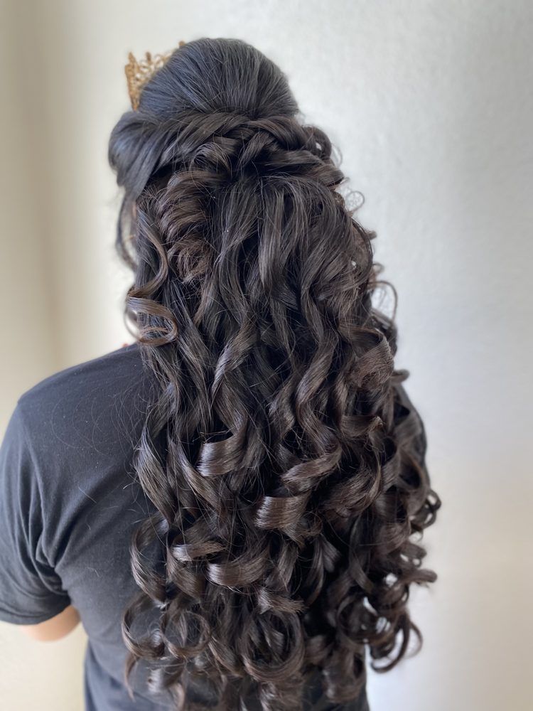 A woman is getting her hair dyed by a hairdresser in a salon.