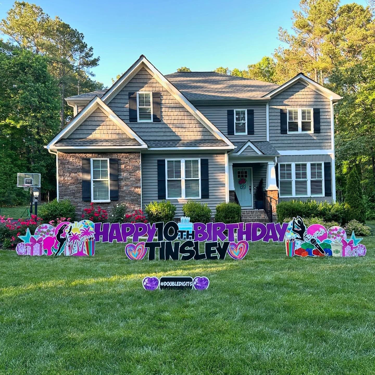 A house with a happy 10th birthday sign in front of it.