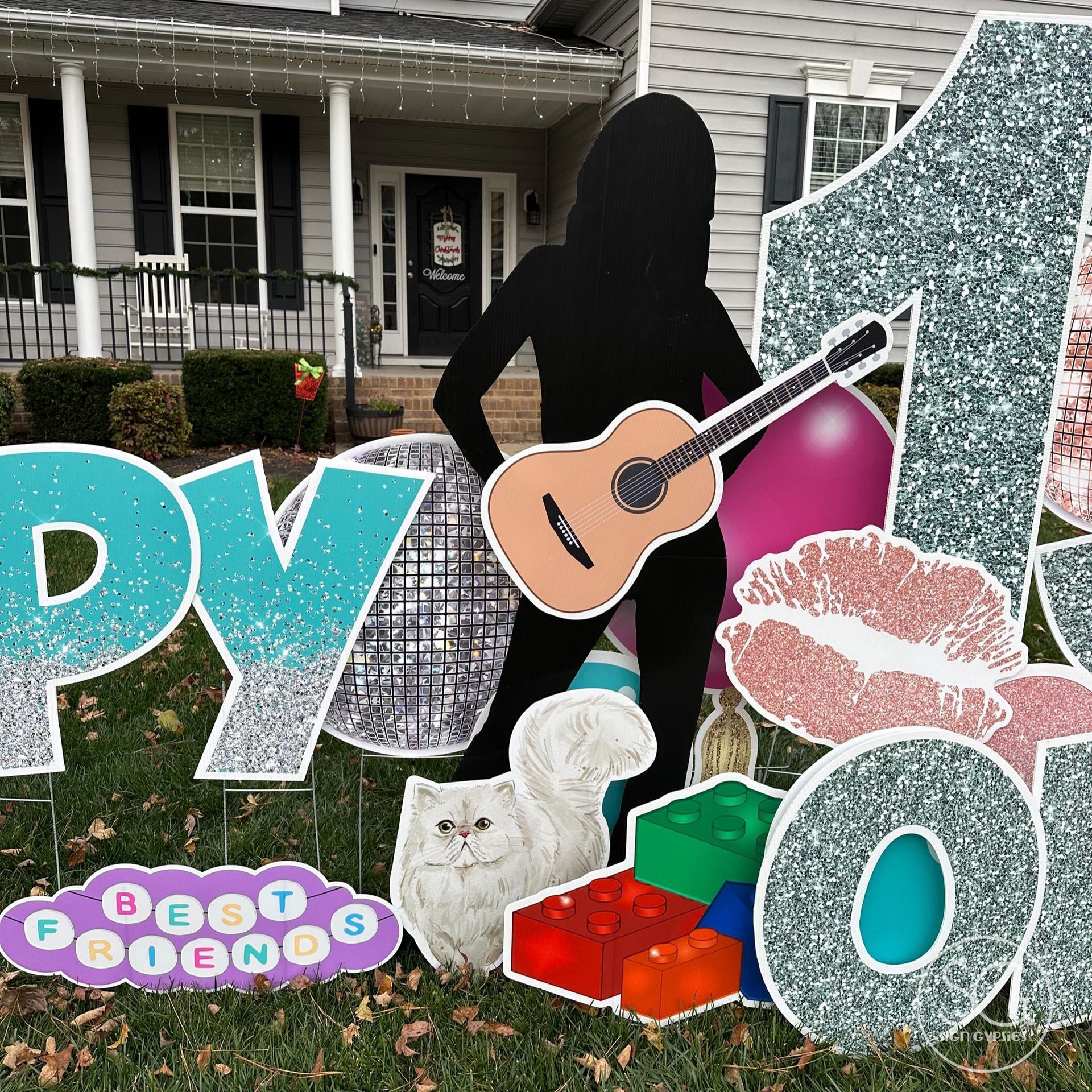 A silhouette of a woman holding a guitar in front of a house