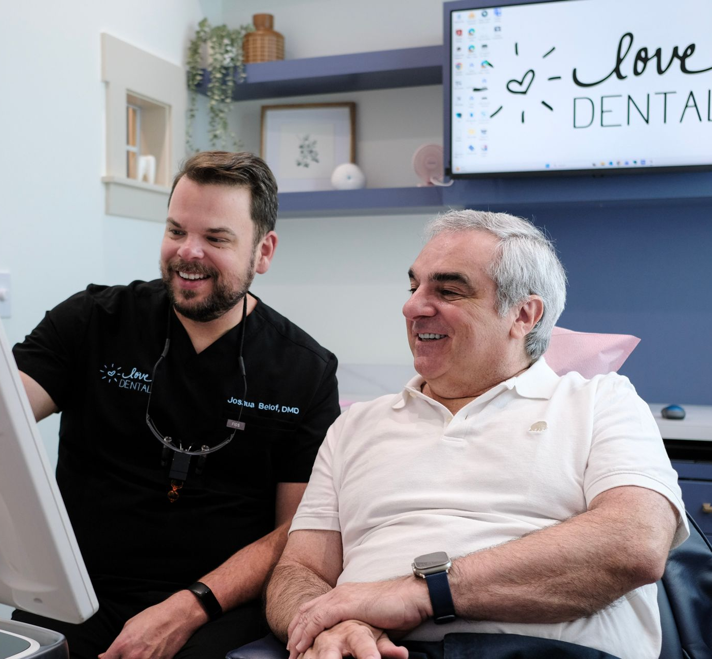 Smiling patient with dental bib as dentist adjusts cheeks with blue-gloved hands
