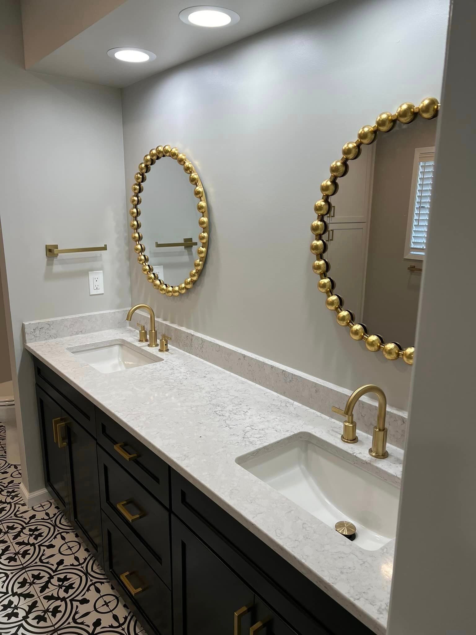 A bathroom with two sinks and two mirrors.