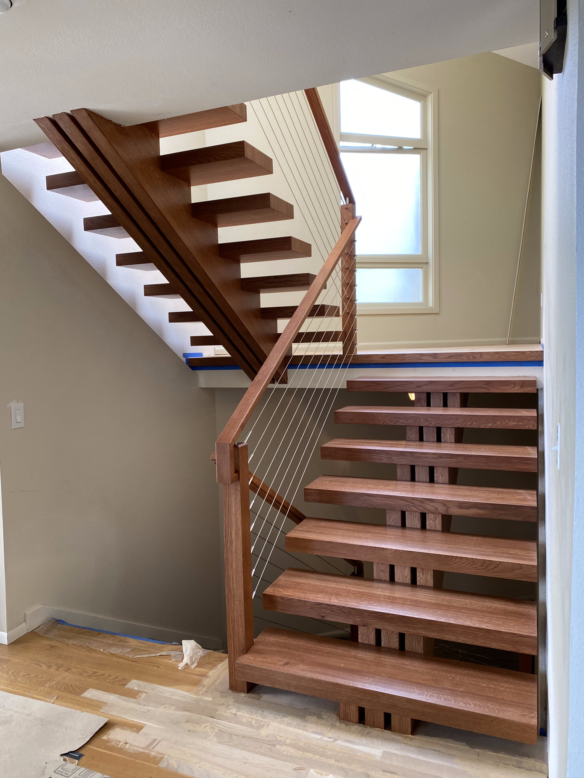 a wooden staircase is being built in a house .