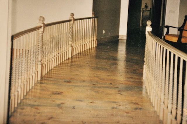 Wooden hallway with balustrade railings.