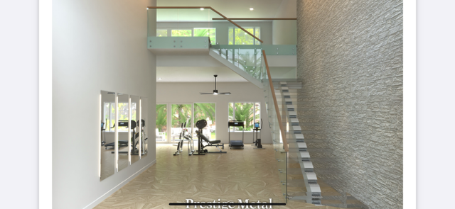 Interior view of a modern gym with a staircase leading to a mezzanine level.