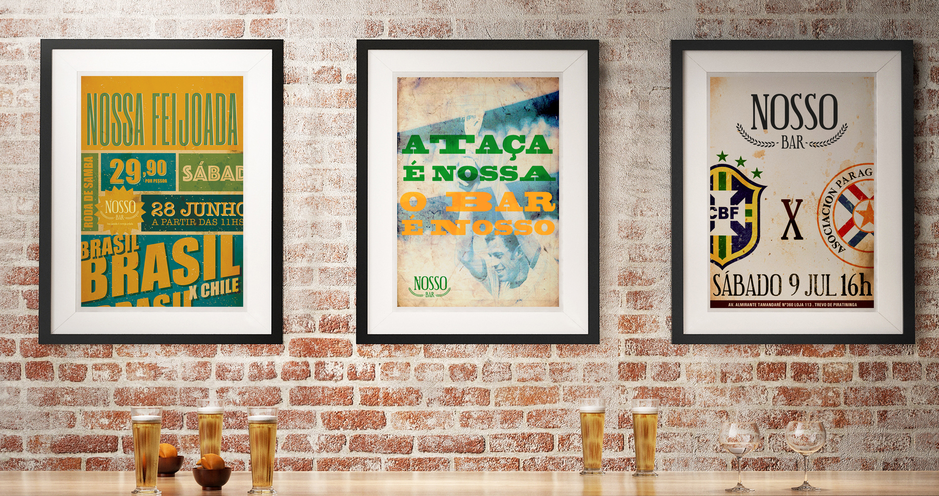 Three framed posters are hanging on a brick wall