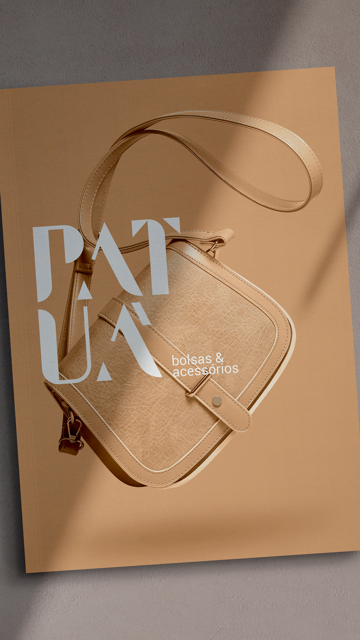 PATUÁ A brown purse is sitting on top of a brown surface.