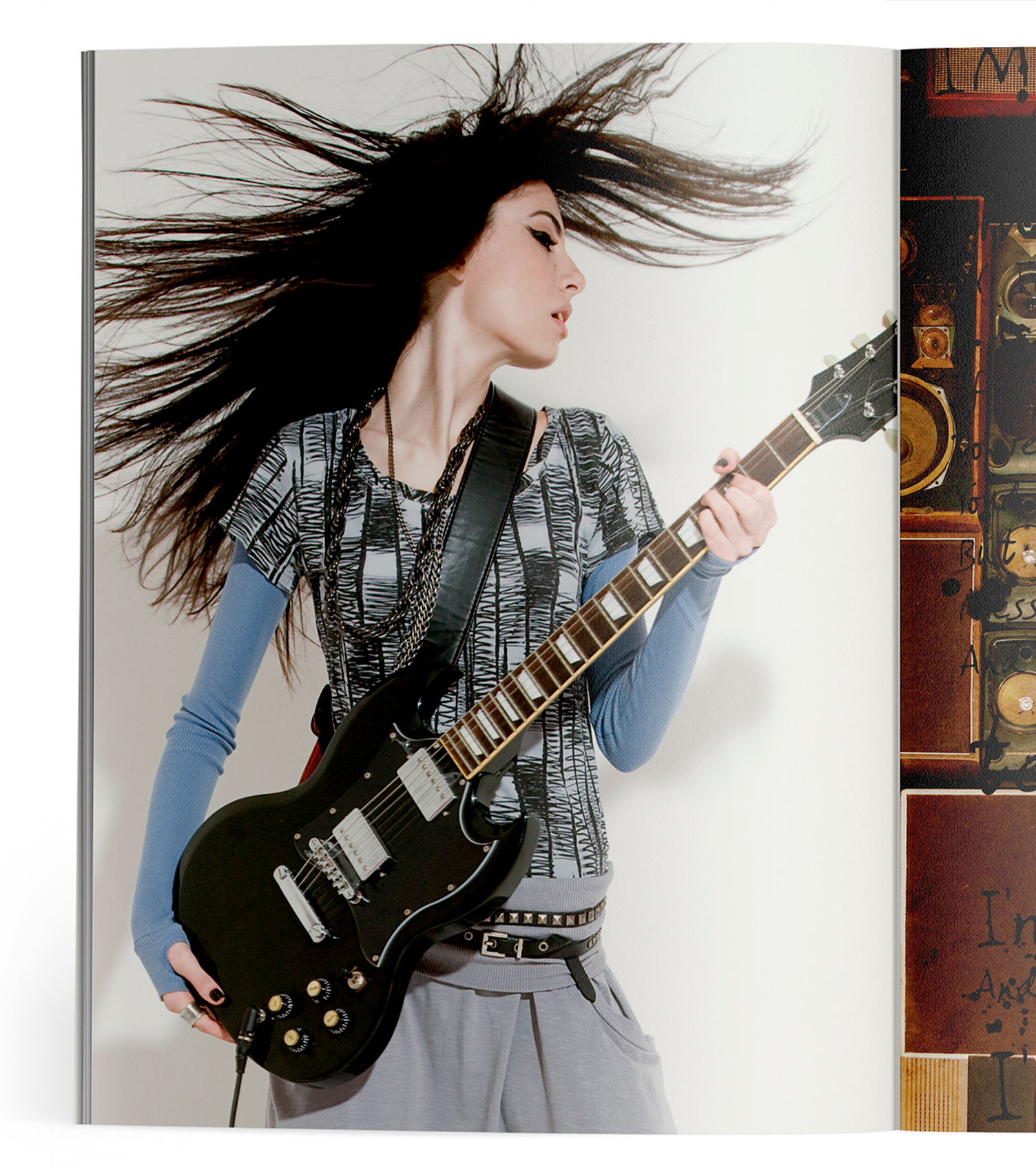 A woman with long hair is playing an electric guitar