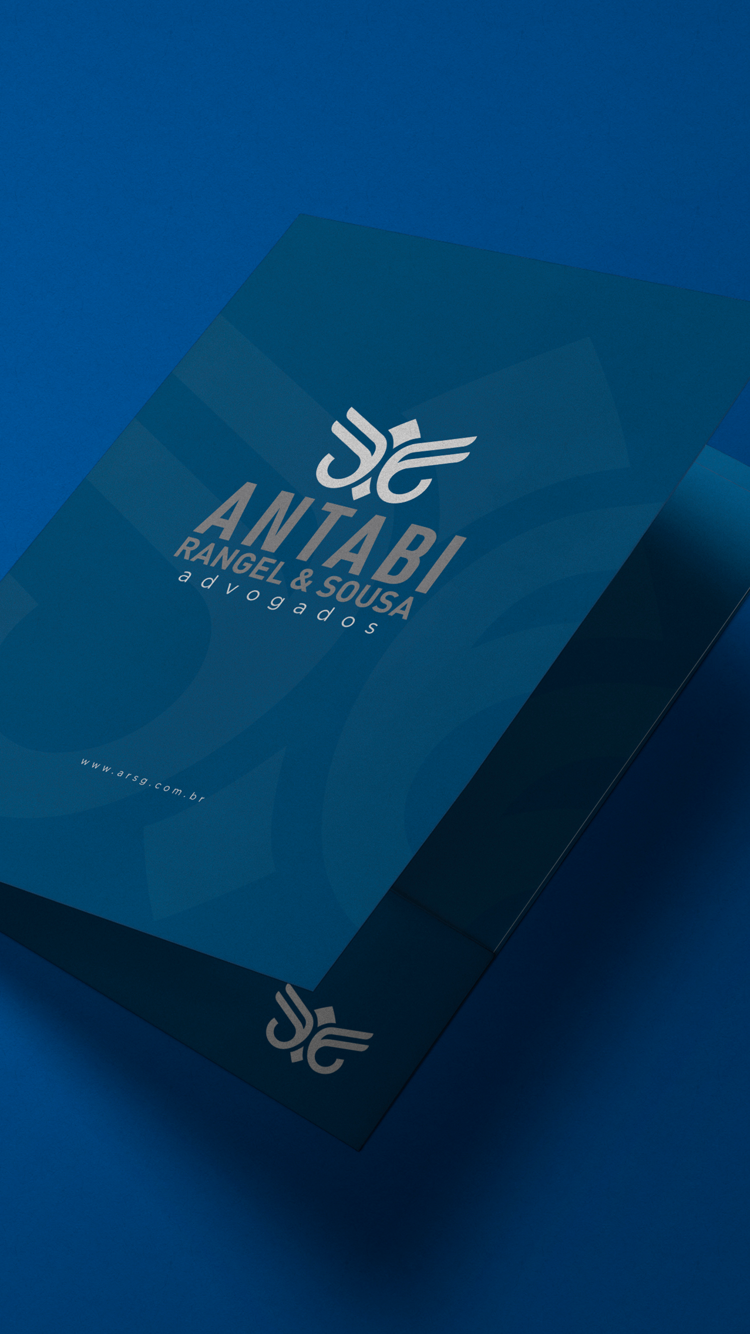 Antabi, Rangel, Sousa, & Goes A blue business card is sitting on top of a blue box.