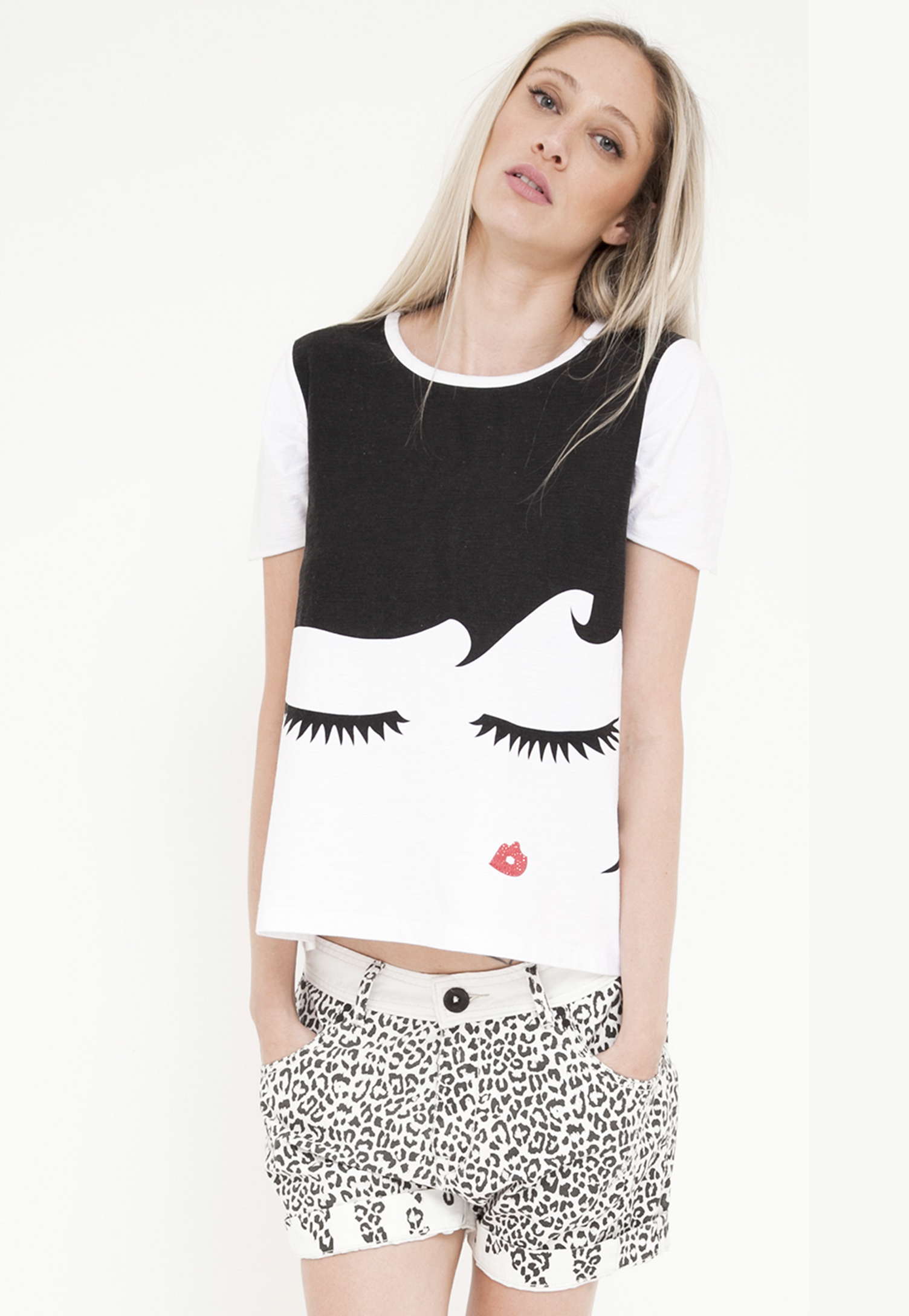 A woman wearing a black and white top with a woman 's face on it