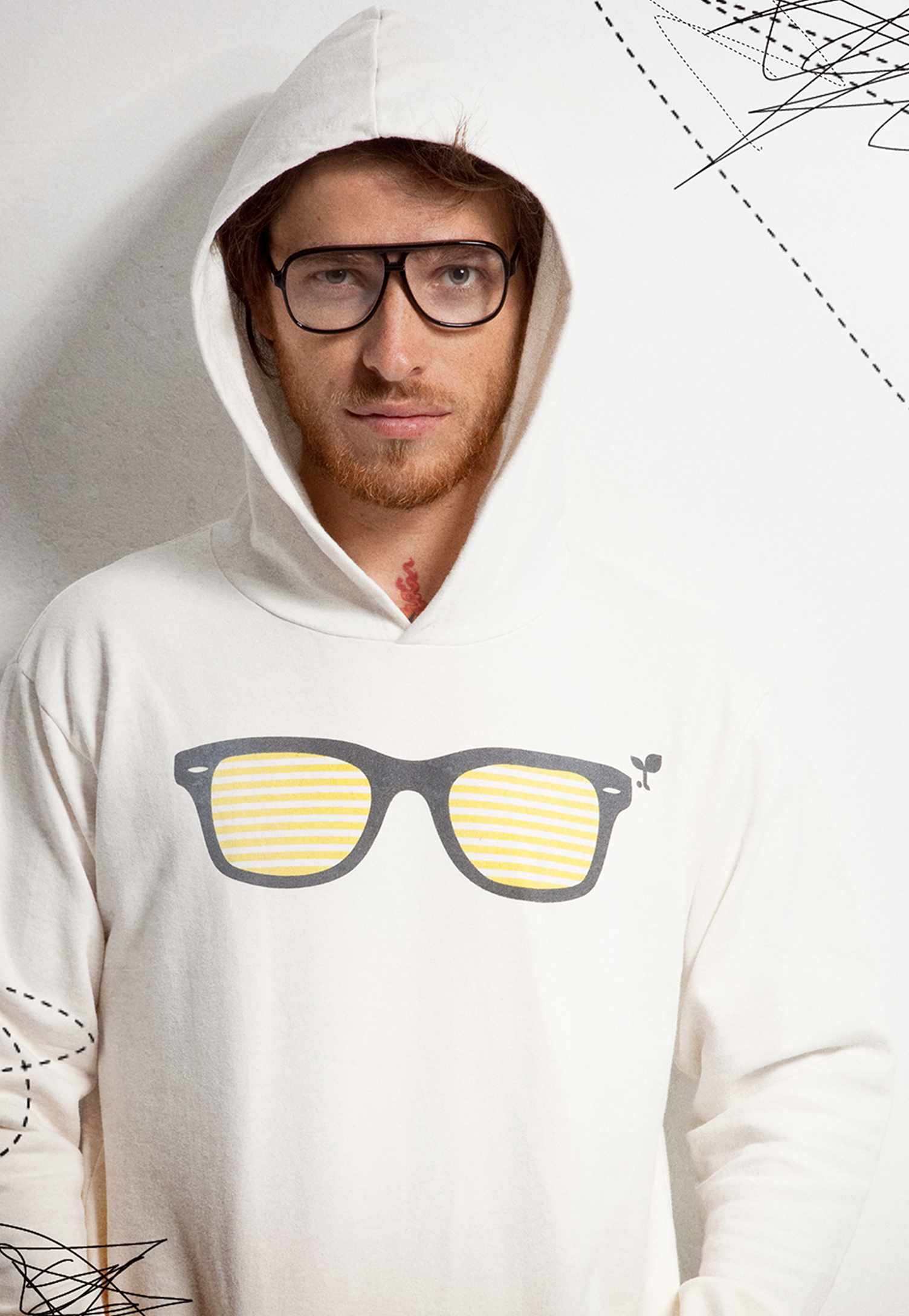 A man wearing a white hoodie with a pair of glasses on it.
