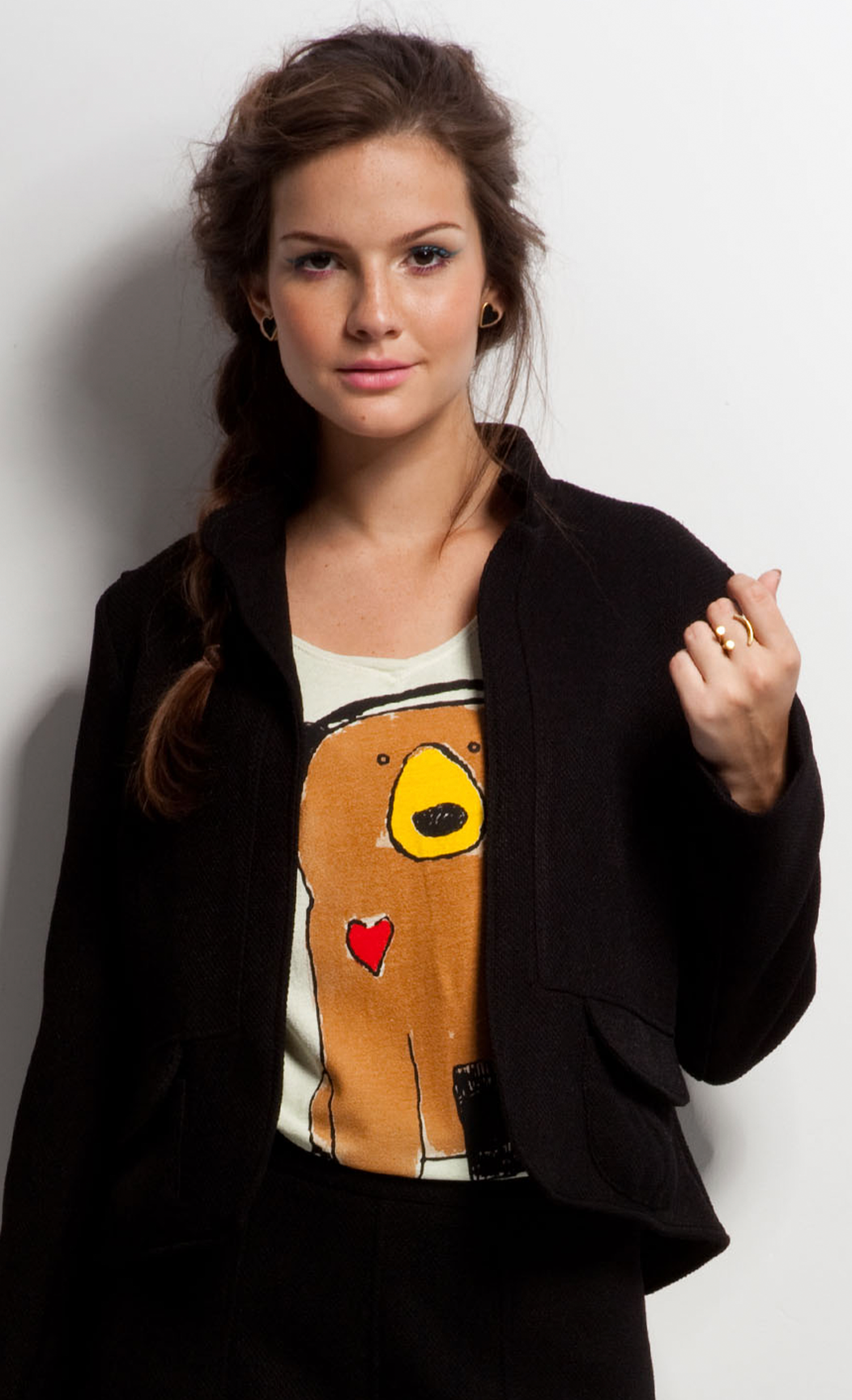 A woman wearing a black jacket and a brown shirt with a dog on it