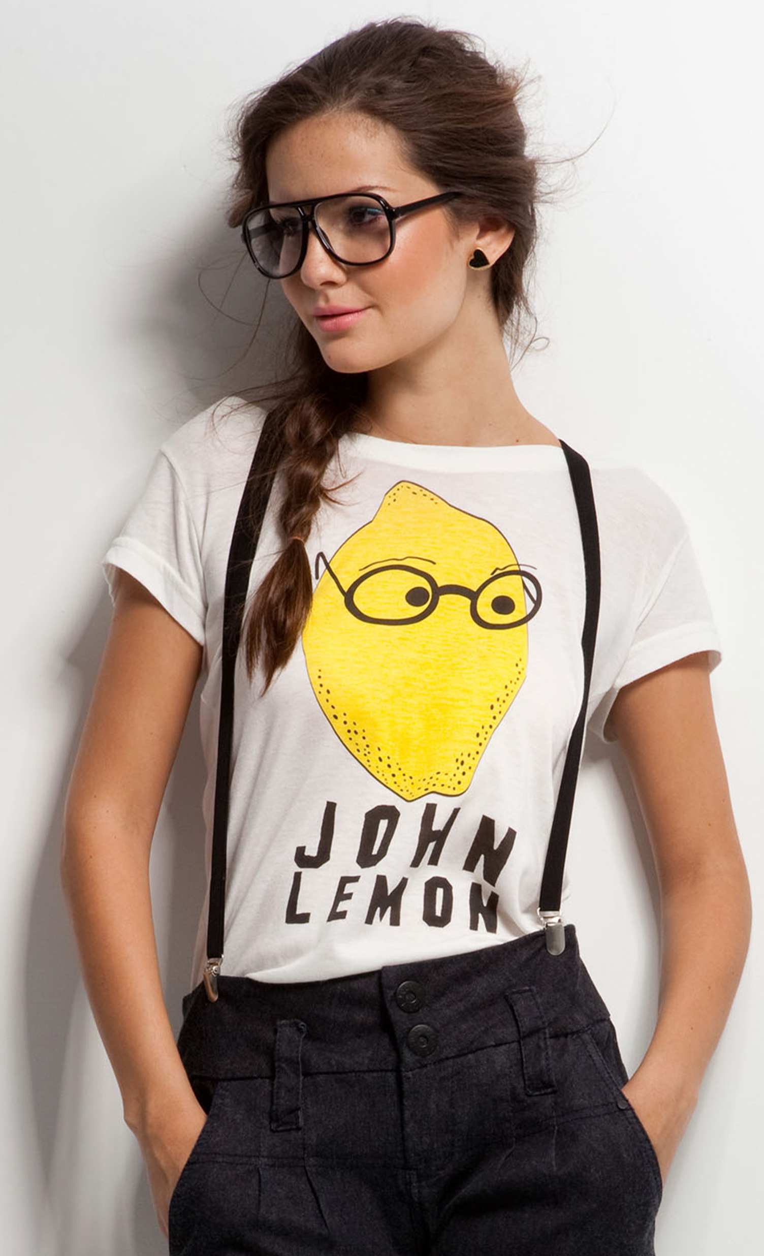 A woman wearing glasses and a t-shirt that says john lemon