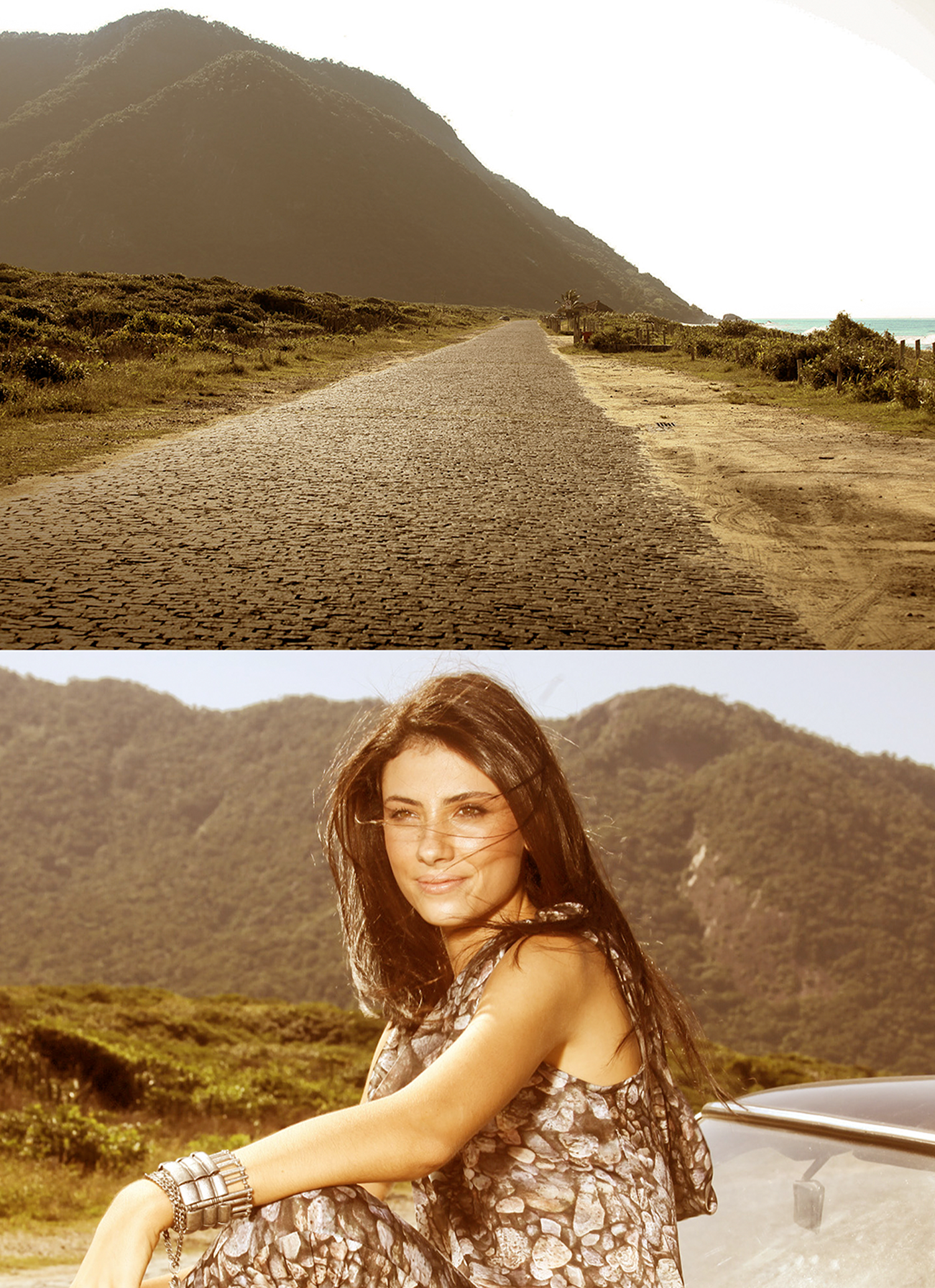 A woman is sitting on the side of a road with mountains in the background