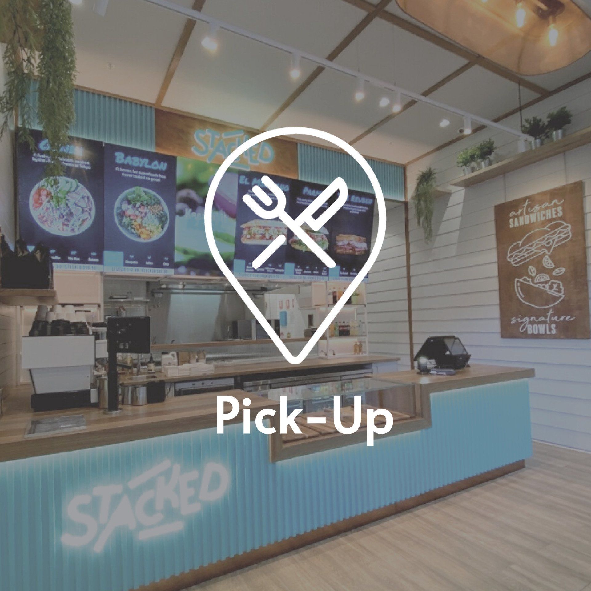 A restaurant service counter with a white map pin icon containing crossed fork and knife symbols above the word Pick-Up.