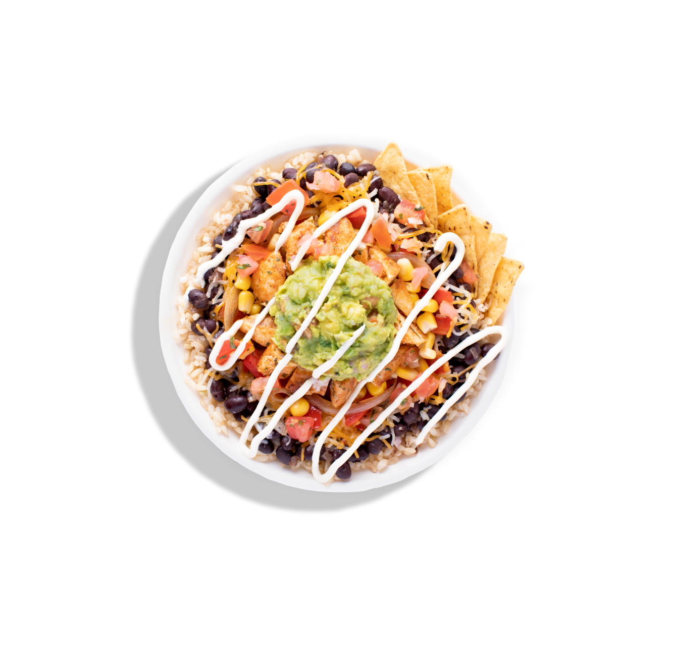 A burrito bowl topped with guacamole, corn salsa, black beans, tortilla chips, and a drizzle of crema.