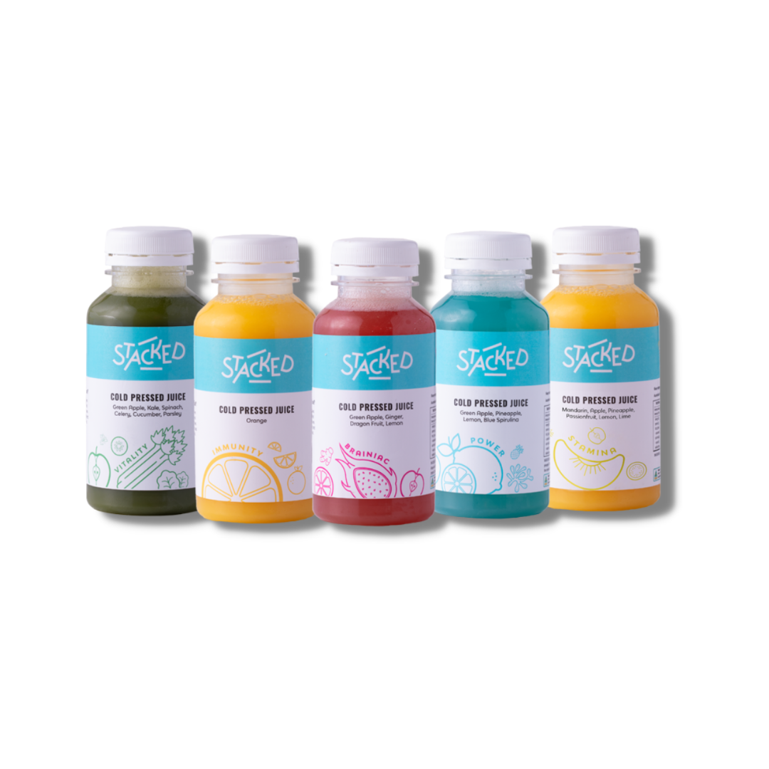 Five bottles of Stacked brand juices in green, yellow, pink, blue, and orange arranged in a row against a white background.