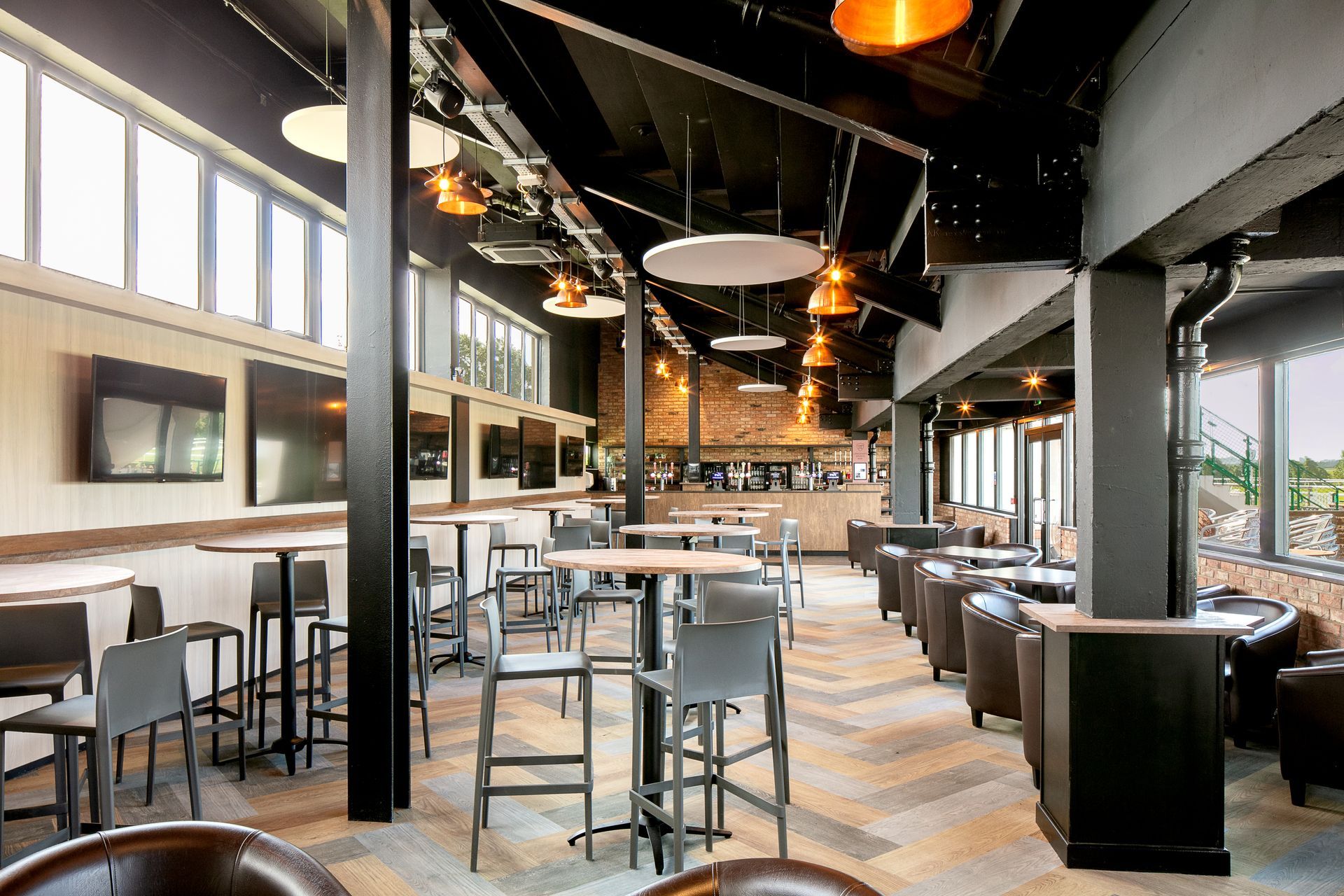 A large room filled with tables and chairs in a restaurant.