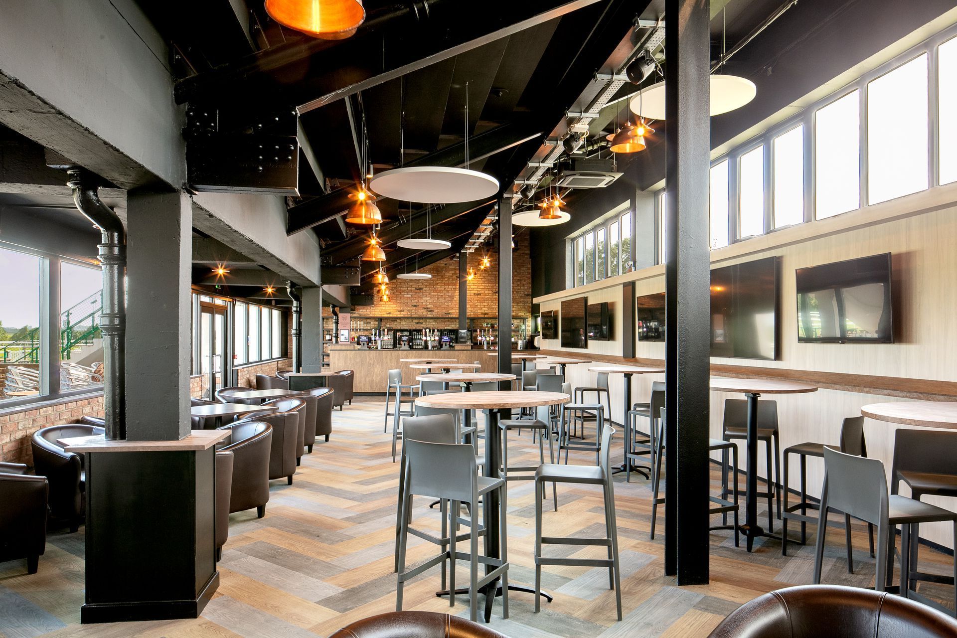 A large room filled with tables and chairs in a restaurant.
