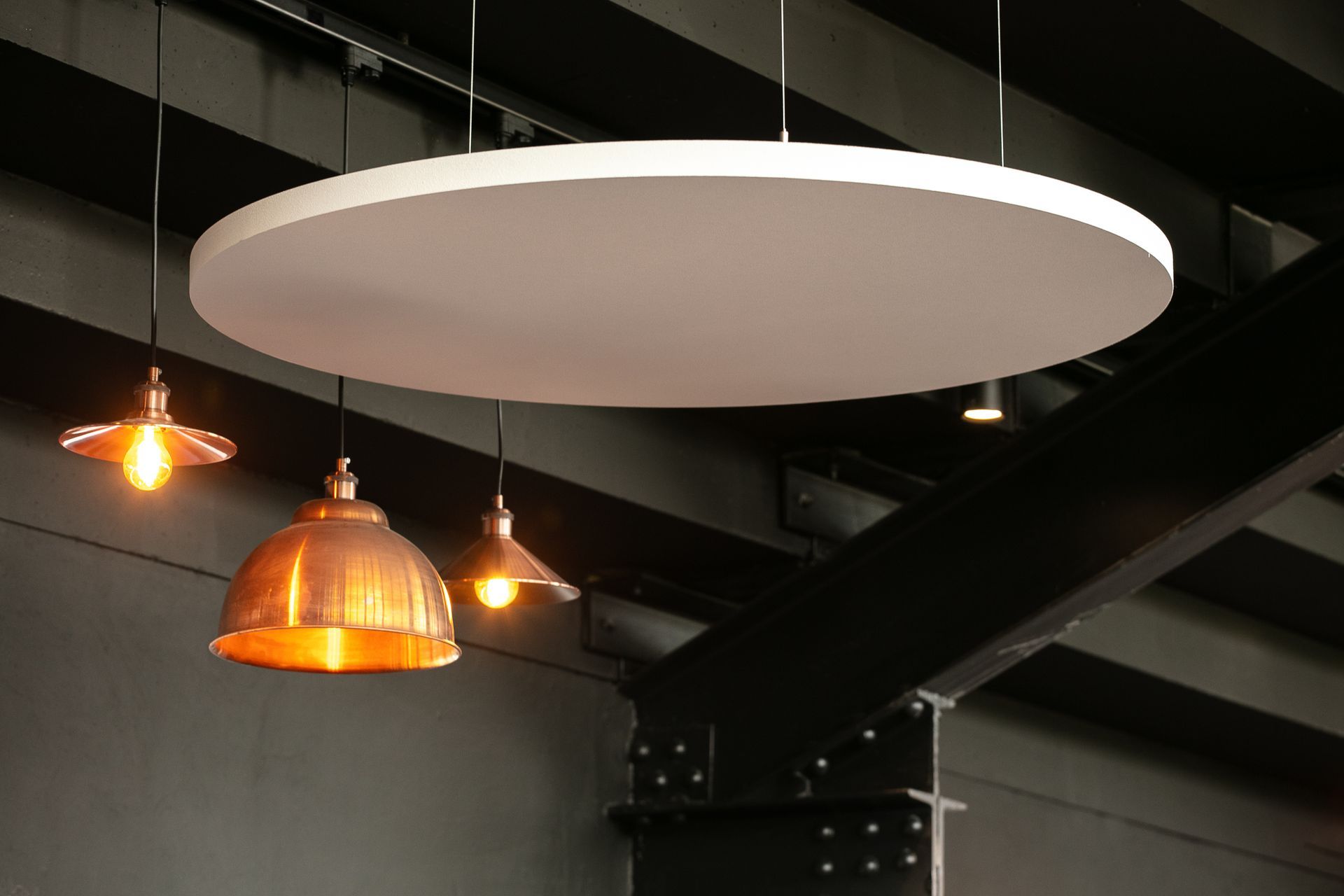 A ceiling with three lights hanging from it