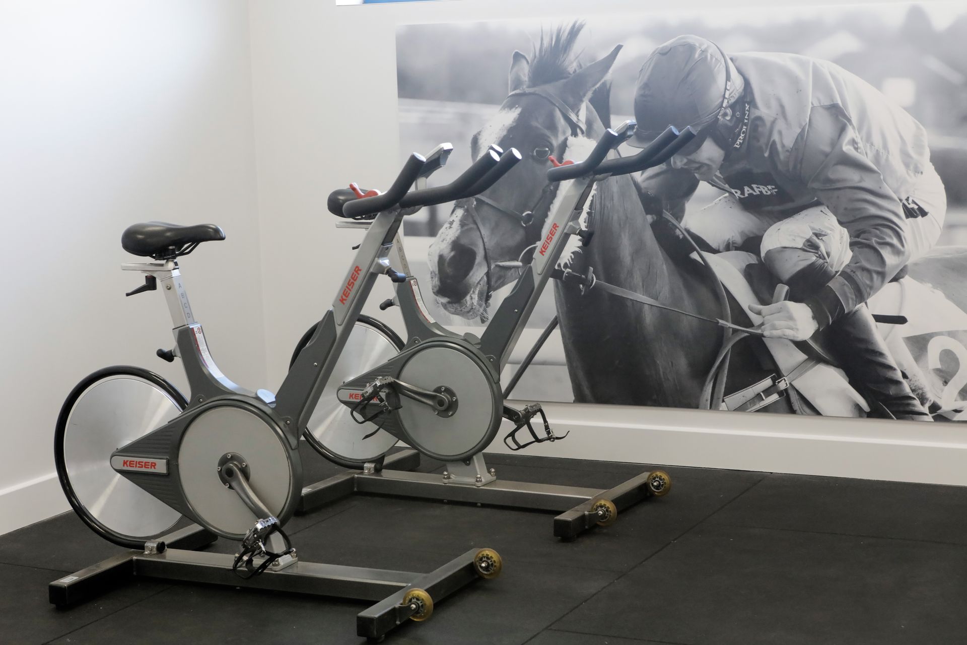 Two exercise bikes are sitting next to each other in a gym.
