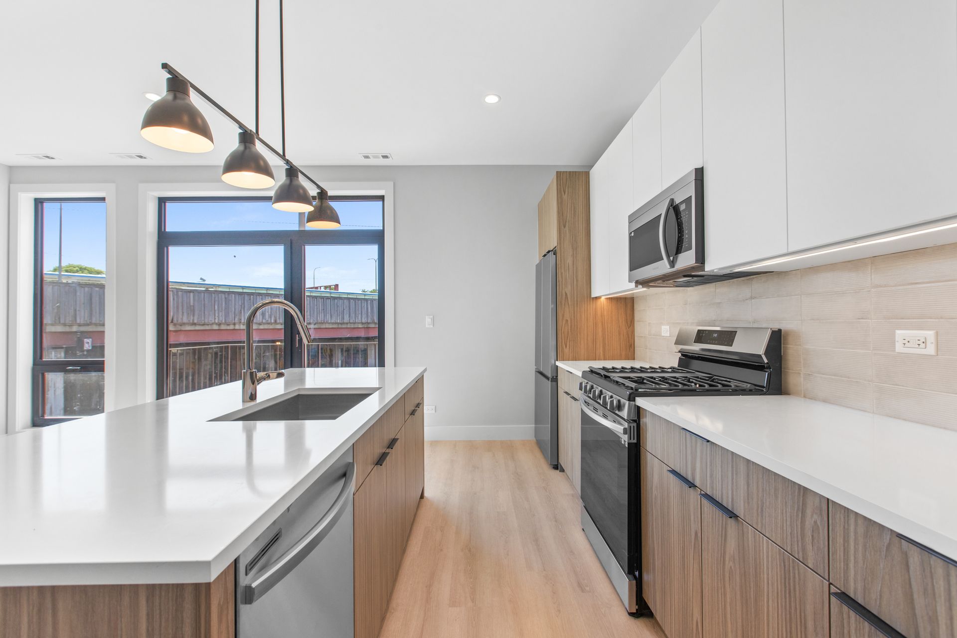 A kitchen with stainless steel appliances and wooden cabinets