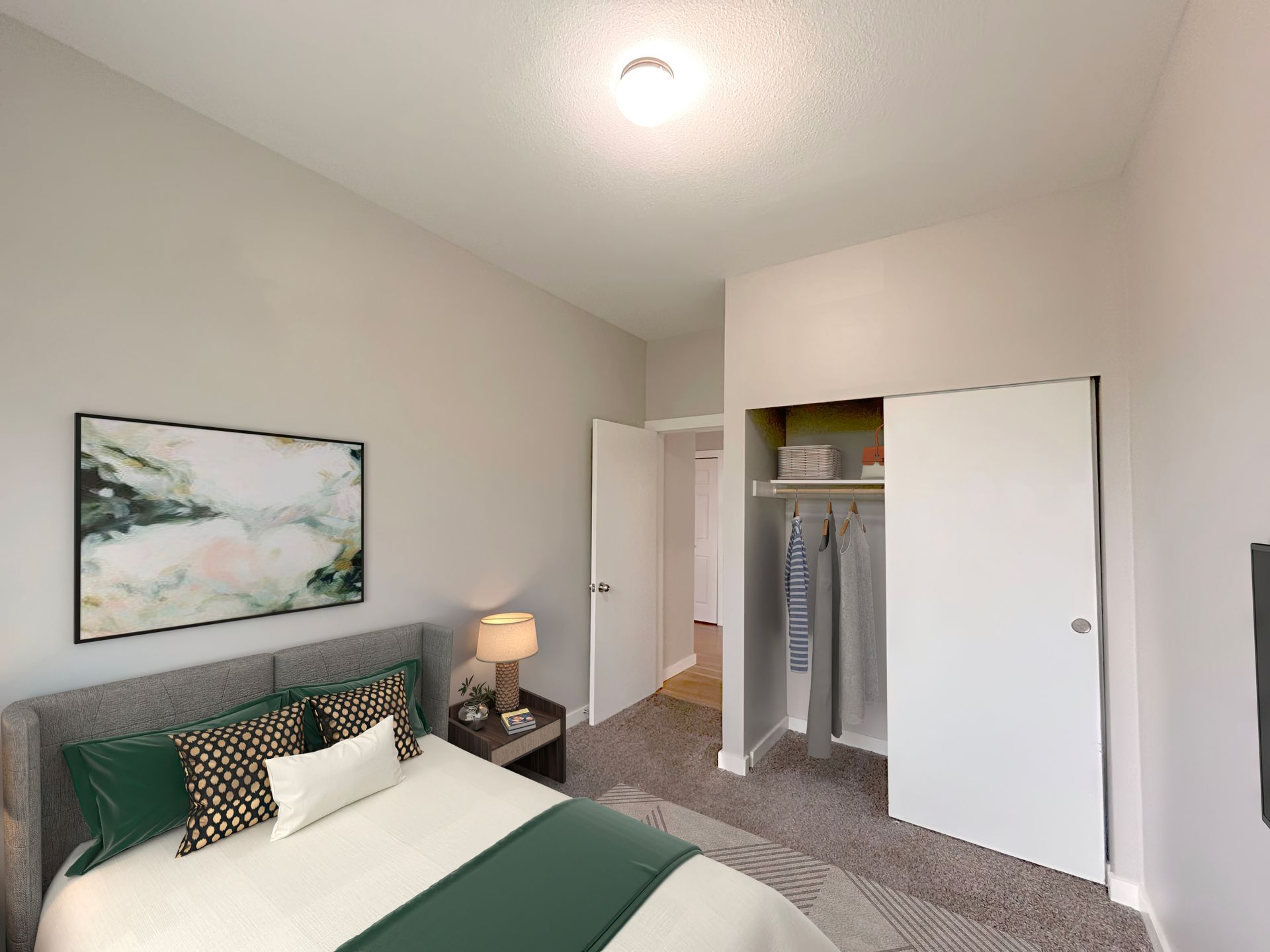 A bedroom with a large bed and a closet.