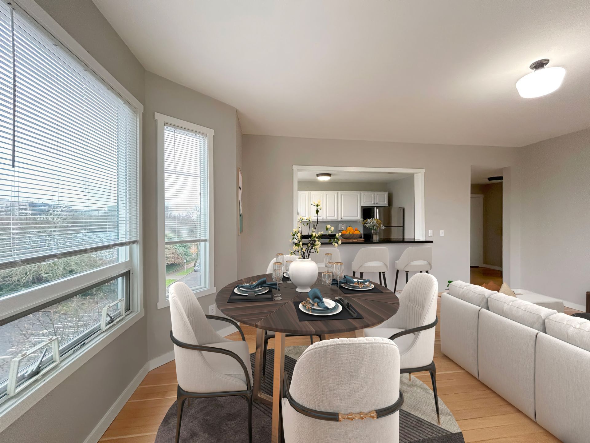 A living room with a dining table and chairs and a couch.