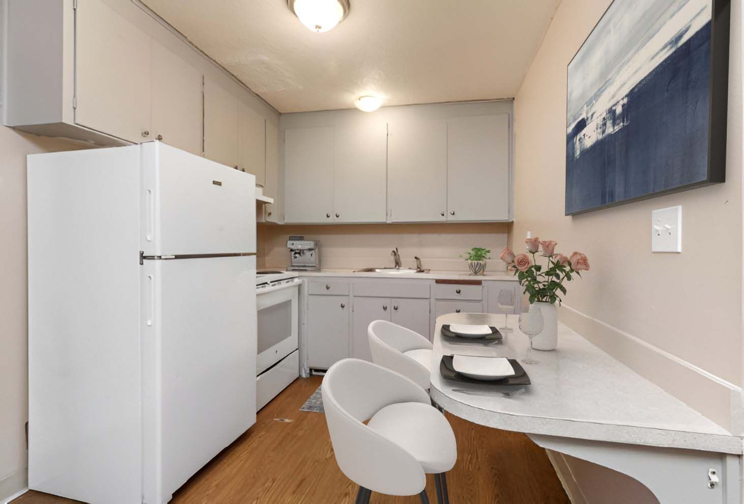 A kitchen with a table and chairs and a refrigerator