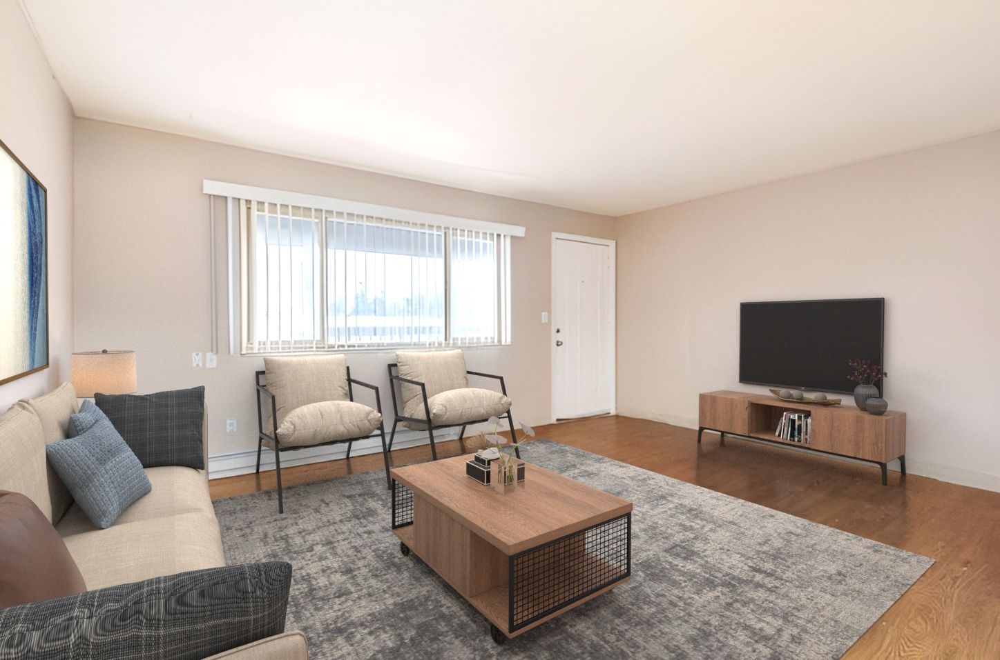 A living room with a couch , chairs , coffee table and television.